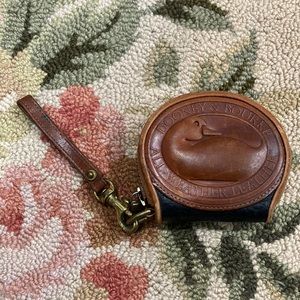 Dooney & Bourke small coin purse wristlet. Black with brown trim.